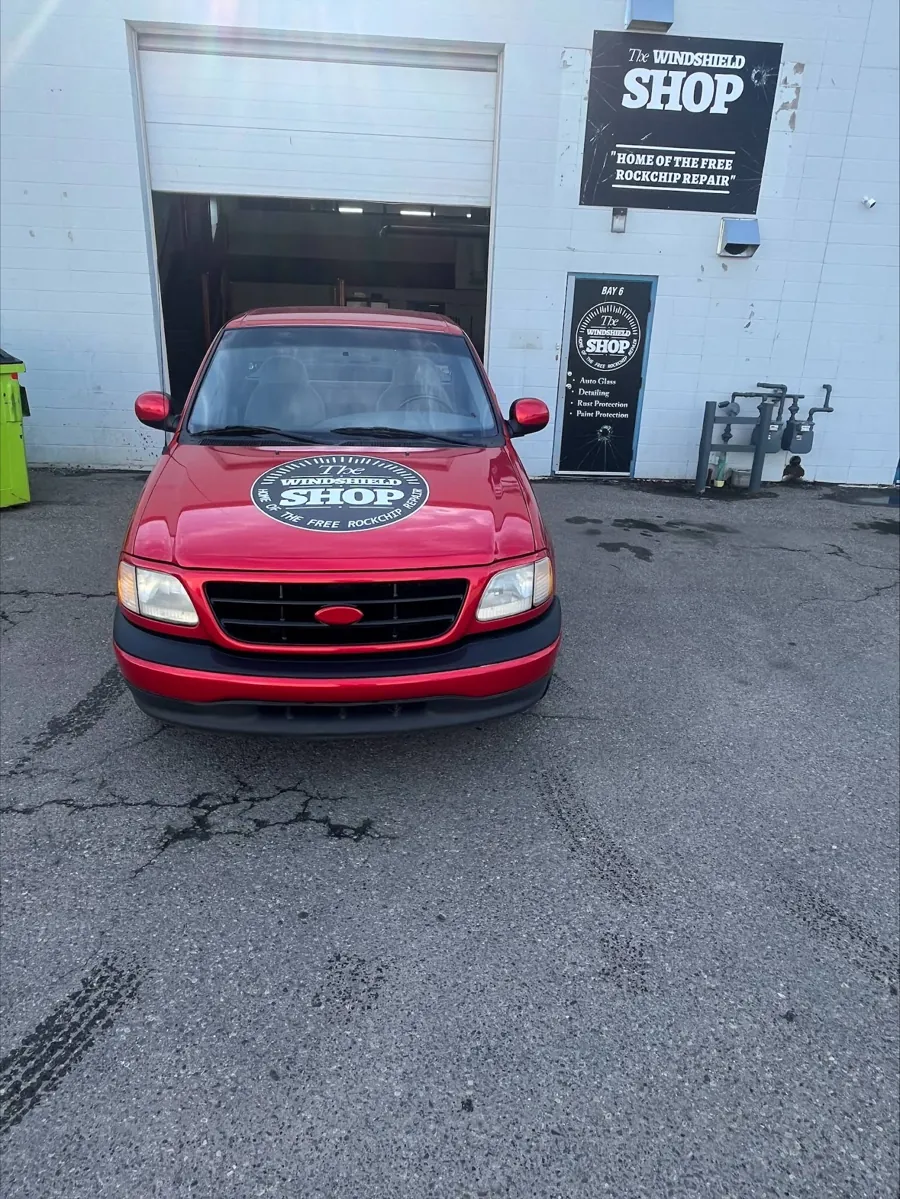 The Windshield Shop branded red truck outside the shop